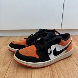 Nike Jordan’s black and orange low tops
